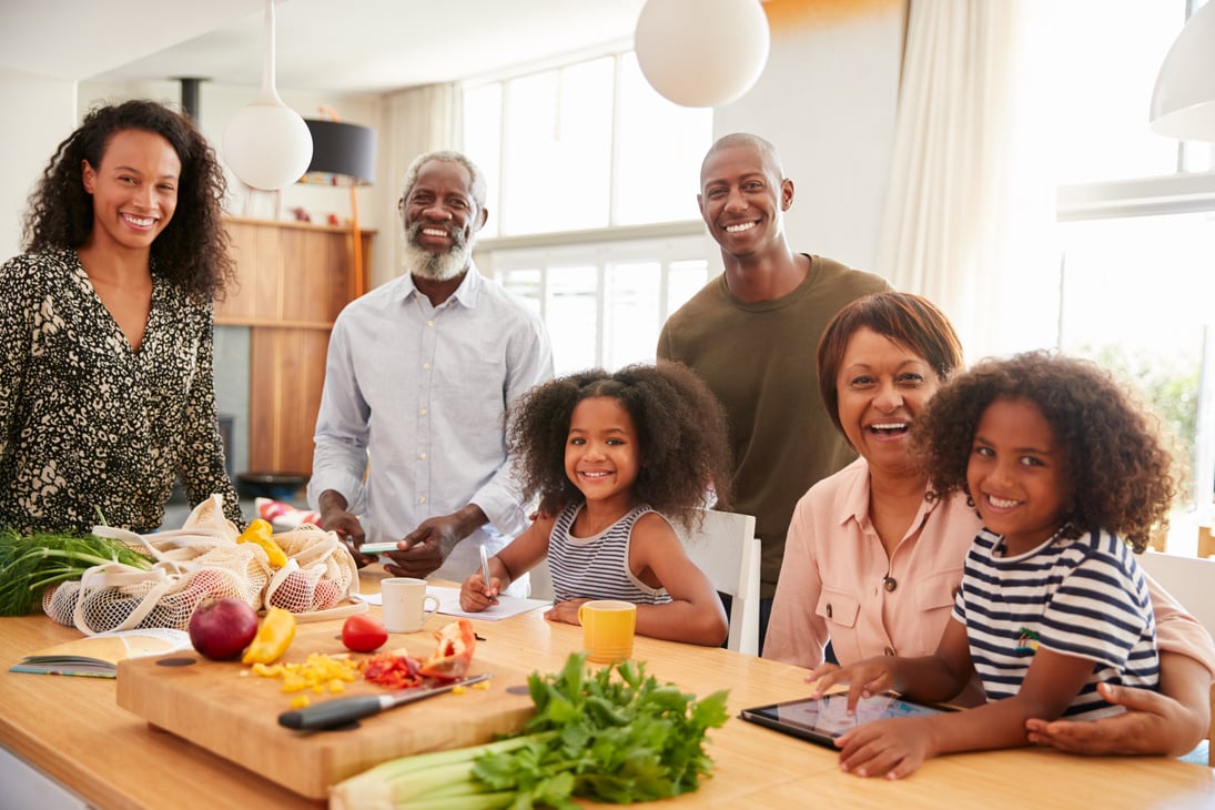 Portrait of Grandparents Sitting at Table with Grandchildren Pla